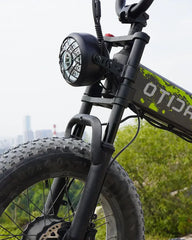 Close-up of a black OTIDA R7 MAX Dual Motor Electric Bike with a cityscape in the background