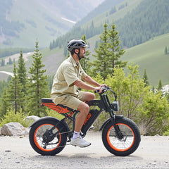 Person riding a VIPCOO VM6 Electric City bicycle on a mountain road with greenery in the background