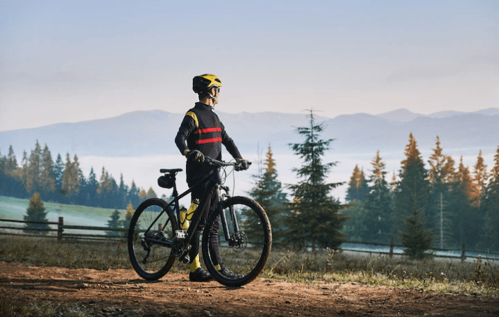 Cyclist with electric bike outdoors, forest background, Pogo Cycles e-bike riding scene
