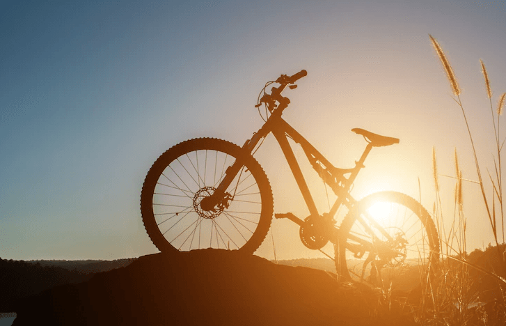 Full suspension electric bike on a hill at sunset, Pogo Cycles e-bike store photography